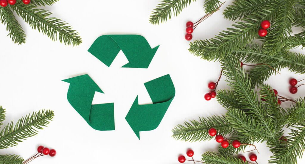 A Christmas themed image with a green felt recycling sign to represent sustainability and carbon reduction.